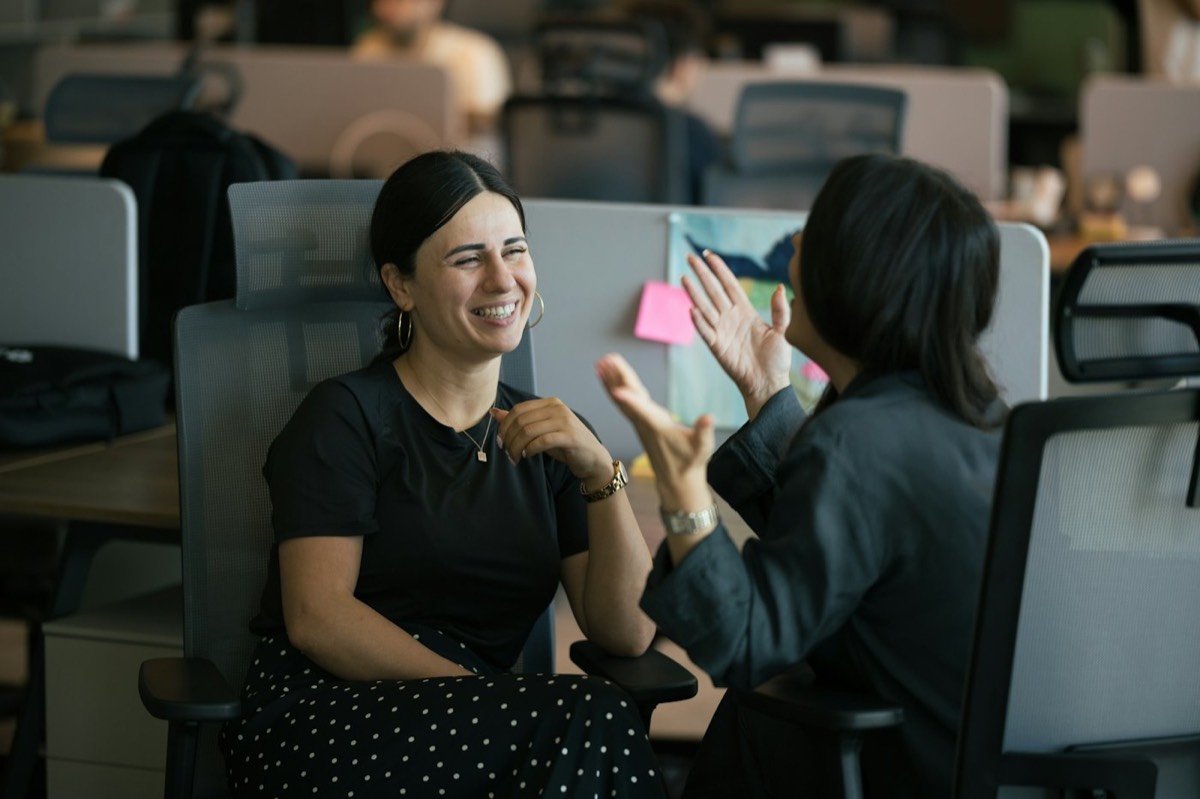 Two women laughing in a meeting